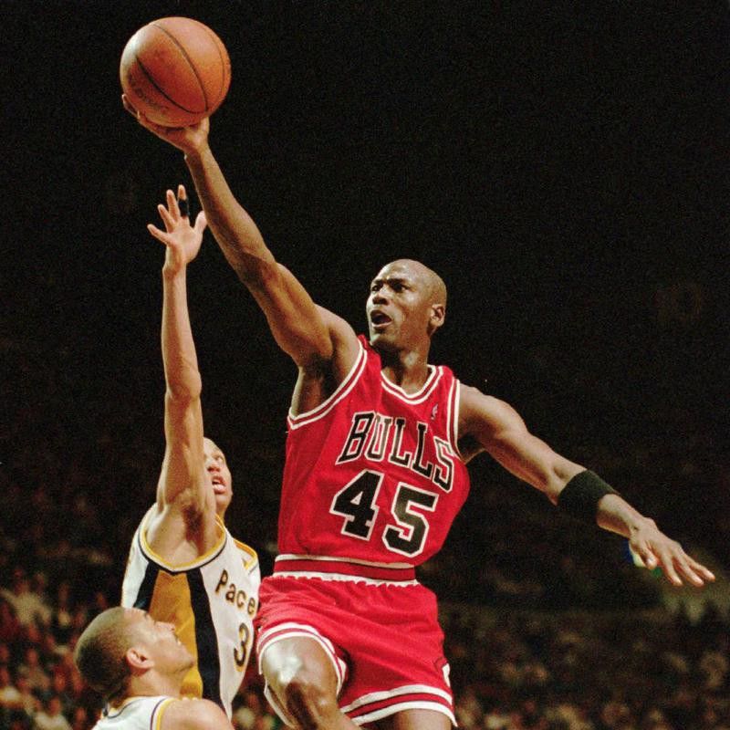 Chicago Bulls guard Michael Jordan flies to hoop over Indiana Pacers' Reggie Miller