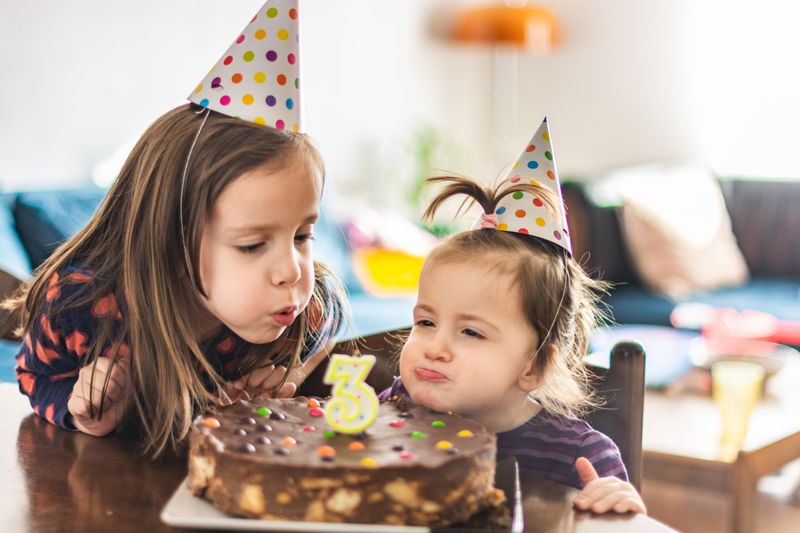 Children blowing birthday candle