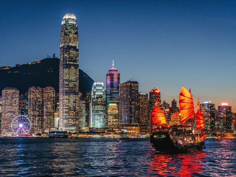 Cityscape Hong Kong and junkboat at twilight