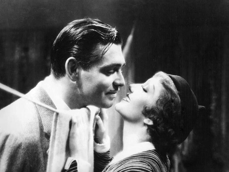 Claudette Colbert smiling at Clark Gable in It Happened One Night
