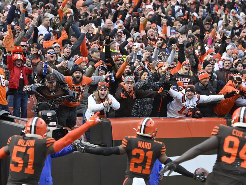 Cleveland Browns fans celebrate with Browns cornerback Denzel Ward and teammates