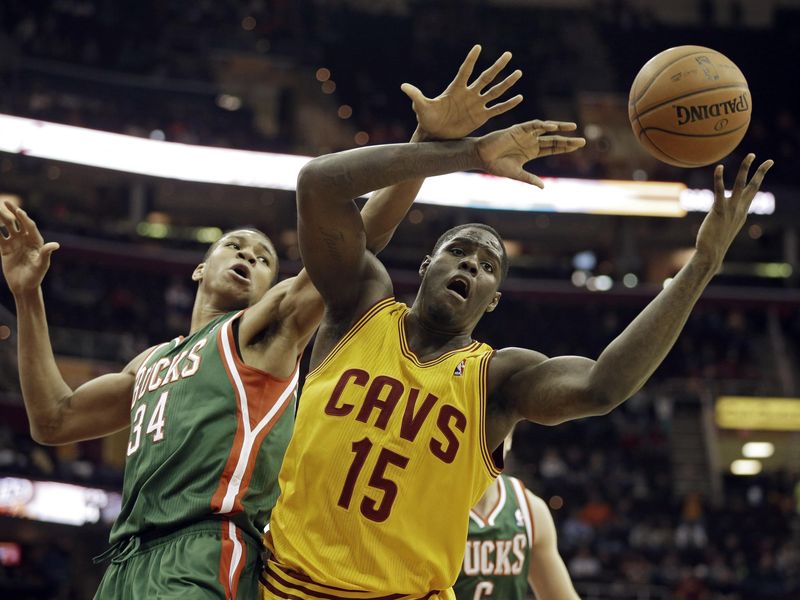 Cleveland Cavaliers forward Anthony Bennett fights for rebound with Milwaukee Buck Giannis Antetokounmpo