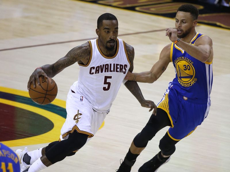 Cleveland Cavaliers guard J.R. Smith drives on Golden State Warriors guard Stephen Curry