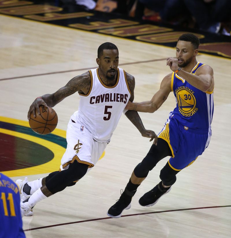 Cleveland Cavaliers guard J.R. Smith drives on Golden State Warriors guard Stephen Curry