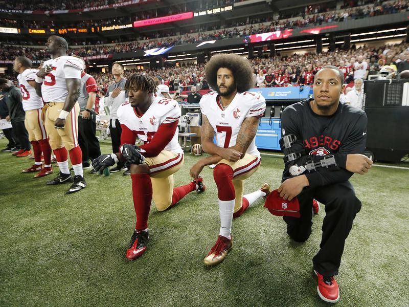 Colin Kaepernick of the San Francisco 49ers kneeling