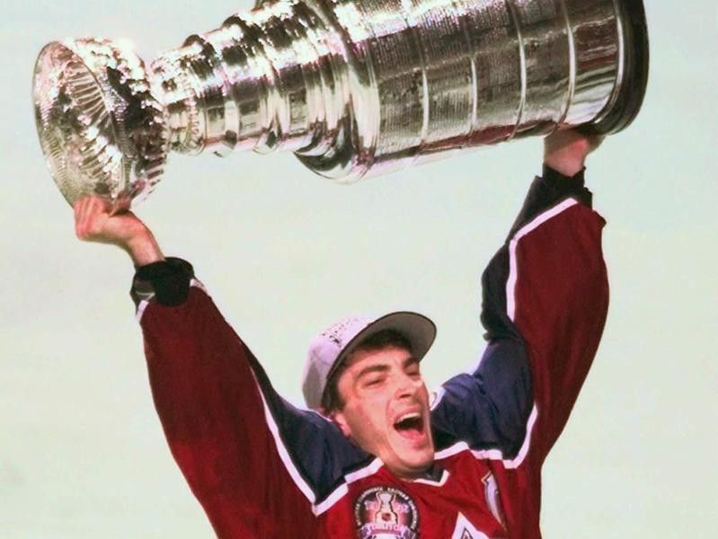 Colorado Avalanche's Joe Sakic hoists the Stanley Cup in the air in celebration