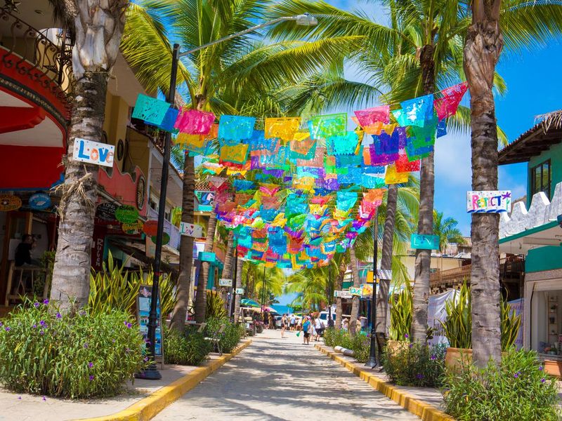 Colorful flags over street in village of Sayulita, Mexico