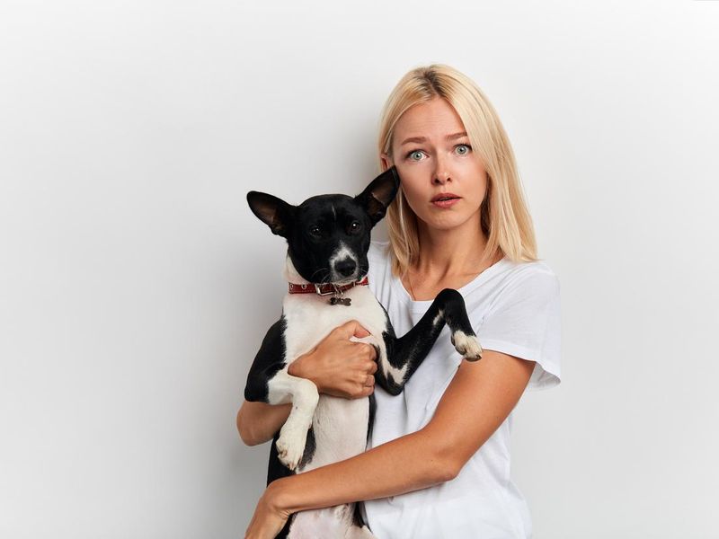Confused woman holding a dog
