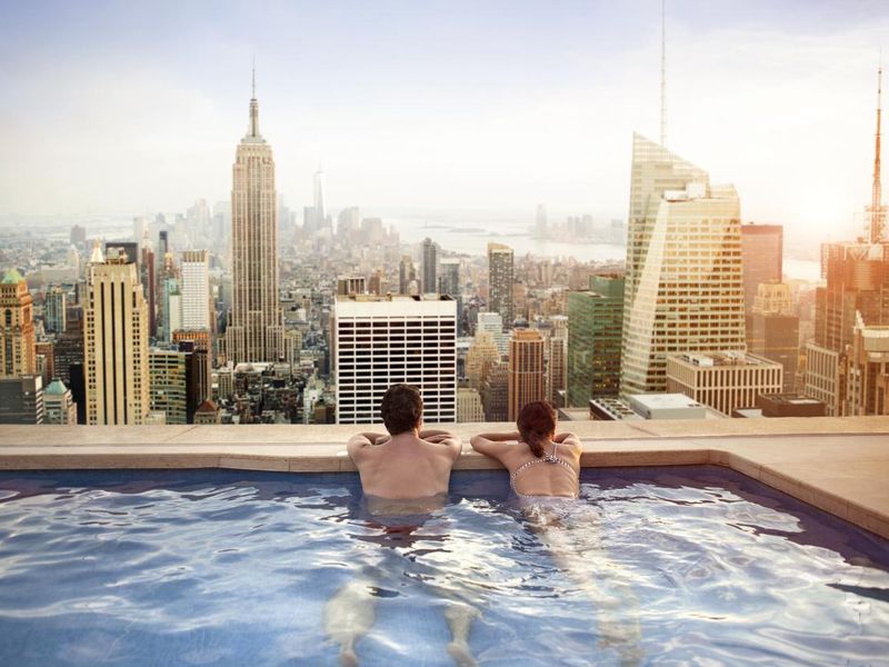 Couple relaxing on hotel rooftop in New York City