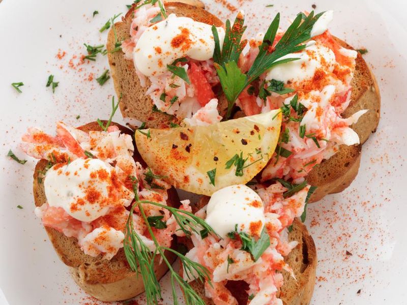 Crab meat with toast, sauce and fresh herbs
