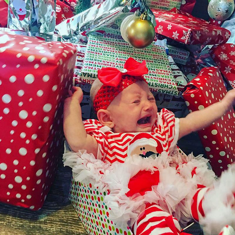 Crying baby in Christmas outfit