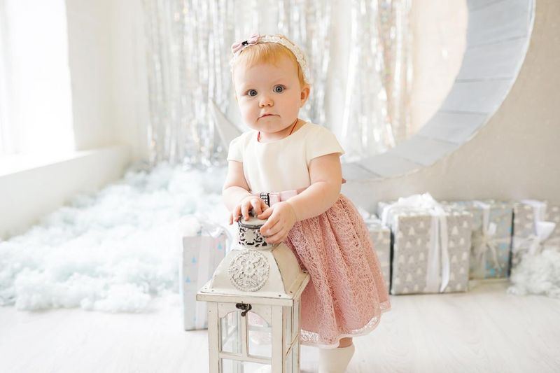 Cute baby girl in a pink dress and with a pink bow