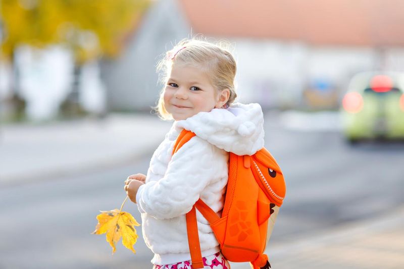 Cute little girl wearing a toddler backpack