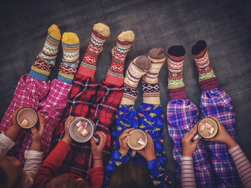 Cute Little Kids in Pyjamas and Christmas Socks Drinking Hot Chocolate with Marshmallows for Christmas