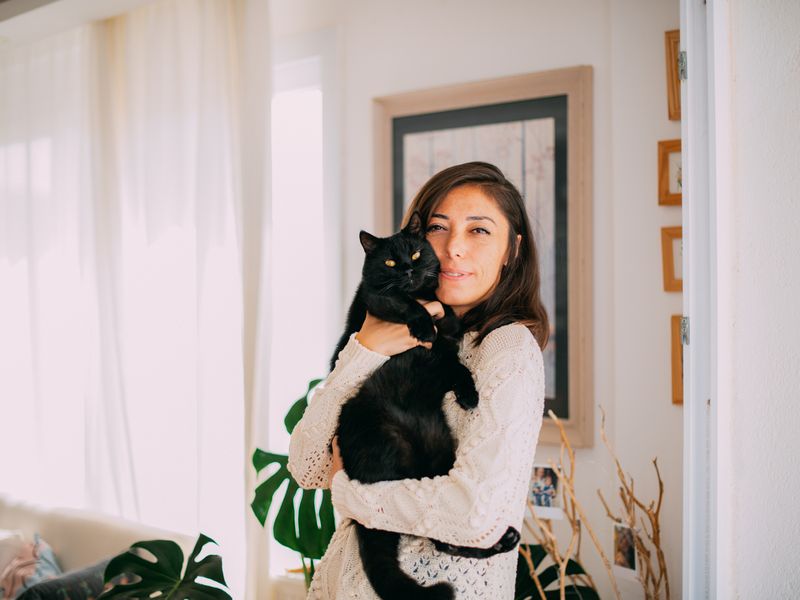 Cute Woman Hugging Her Black Cat
