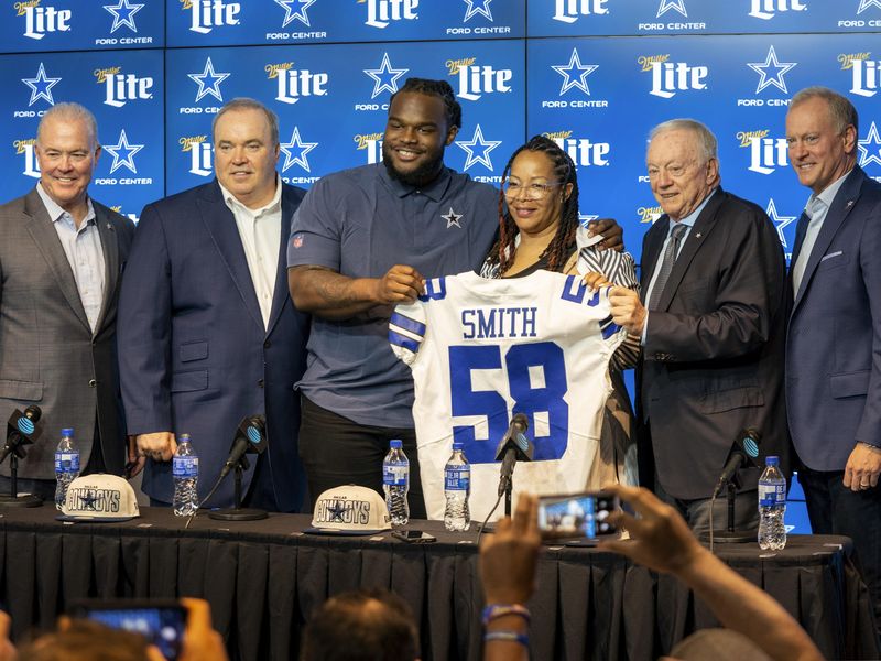 Dallas Cowboys 2023 first-round draft pick Mazi Smith and his mother Kenya Smith with Cowboys brass