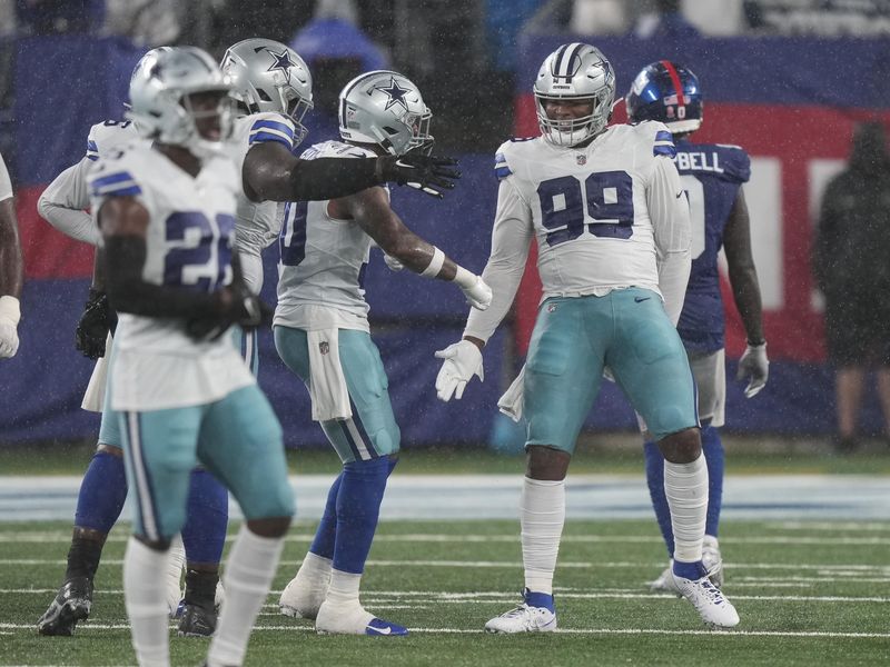 Dallas Cowboys defensive tackle Chauncey Golston celebrates with teammates