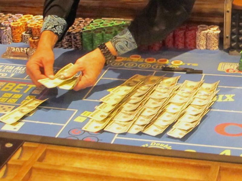 Dealer counts money at a casino table