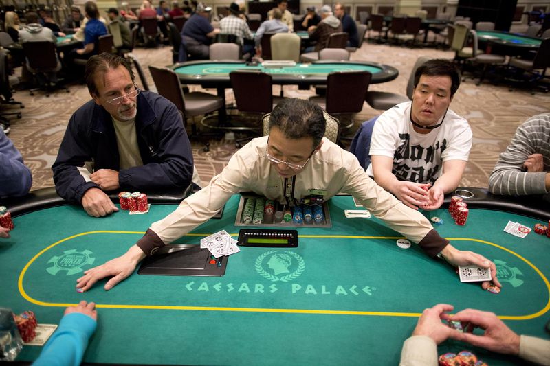 Dealer gathers chips after a hand of Texas Hold'em at a poker room in Caesar's Palace in Las Vegas