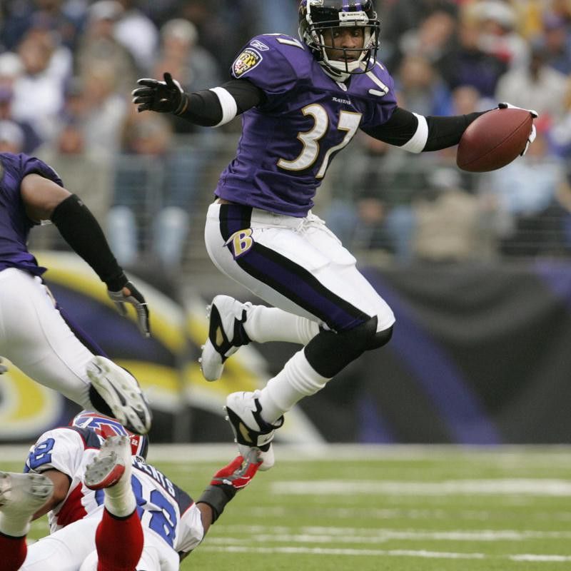Deion Sanders of the Baltimore Ravens hops over Nate Clements