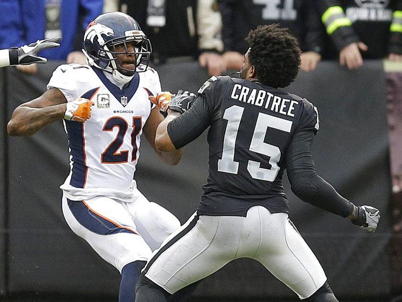 Denver Broncos defensive back Aqib Talib fights Oakland Raiders wide receiver Michael Crabtree