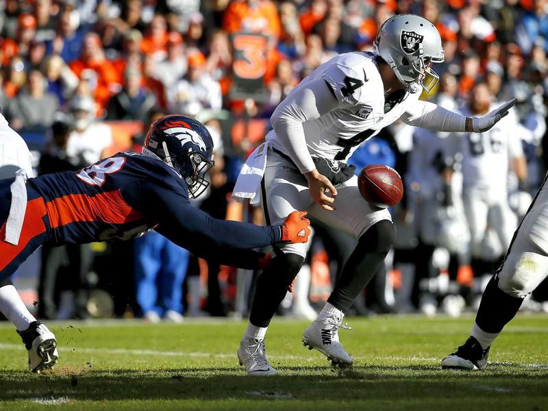 Denver Broncos outside linebacker Von Miller forces Oakland Raiders quarterback Derek Carr to fumble