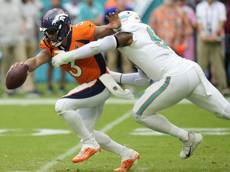 Denver Broncos quarterback Russell Wilson sacked by Miami Dolphins defensive end Emmanuel Ogbah