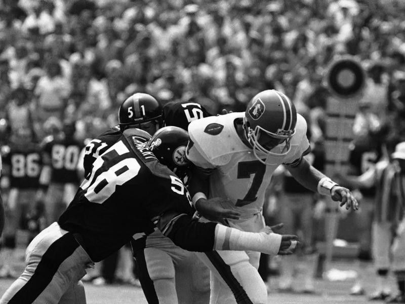 Denver Broncos rookie quarterback John Elway hauled down by Pittsburgh Steelers Jack Lambert