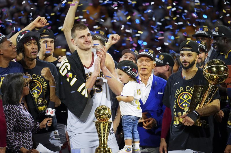 Denver Nuggets center Nikola Jokic celebrates with teammates after winning 2023 NBA championship