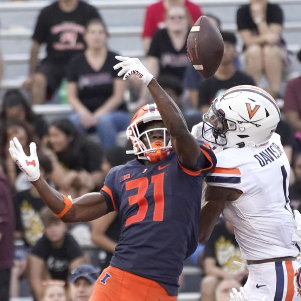 Illinois defensive back Devon Witherspoon breaks up a pass in the end zone intended for Virginia's Lavel Davis Jr., during the second half of an NCAA college football game Saturday, Sept. 10, 2022, in Champaign, Ill. Illinois won 24-3. (AP Photo/Charles Rex Arbogast)