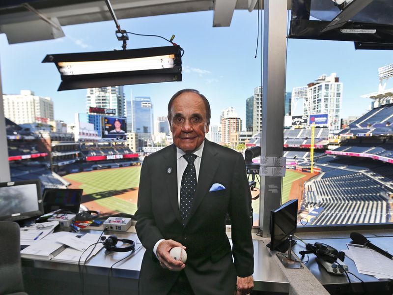Dick Enberg poses in booth