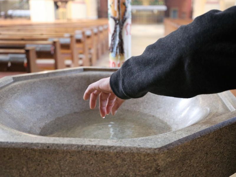 Dipping fingers in holy water