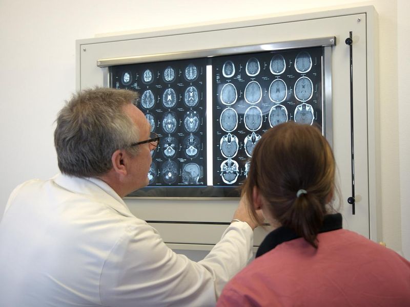 Doctor with female assistent analyzing an MRI scan