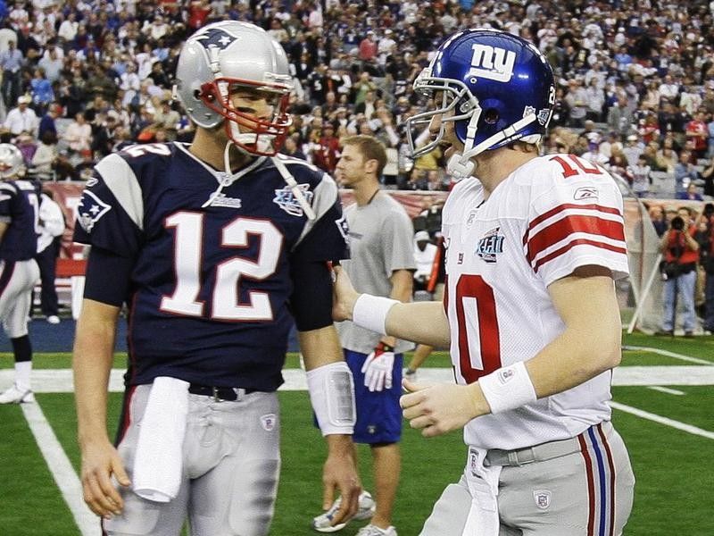 Eli Manning greets Tom Brady
