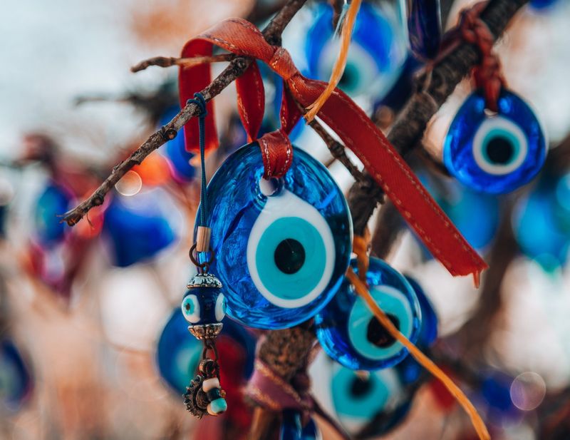 Evil eye charms hanging on tree