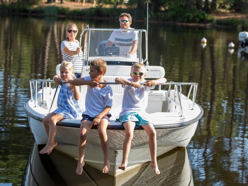 Family enjoying a summer day on a boat