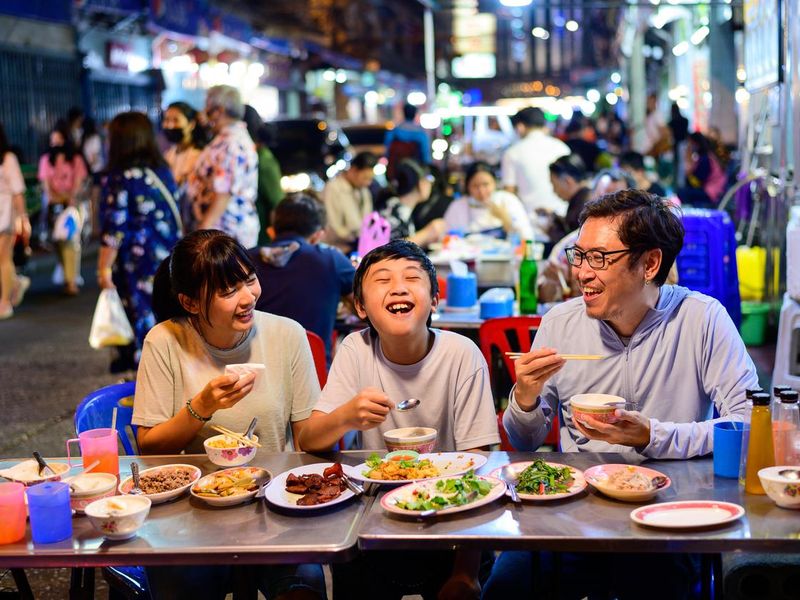 Family enjoying food at Yaowarat road, Bangkok