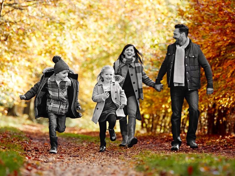 Family walking together in autumn countryside