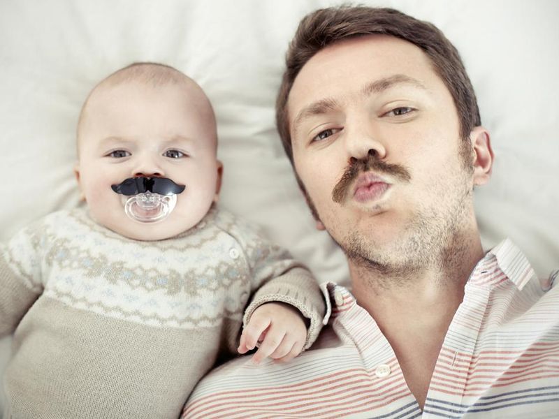 Father and young son both with mustaches