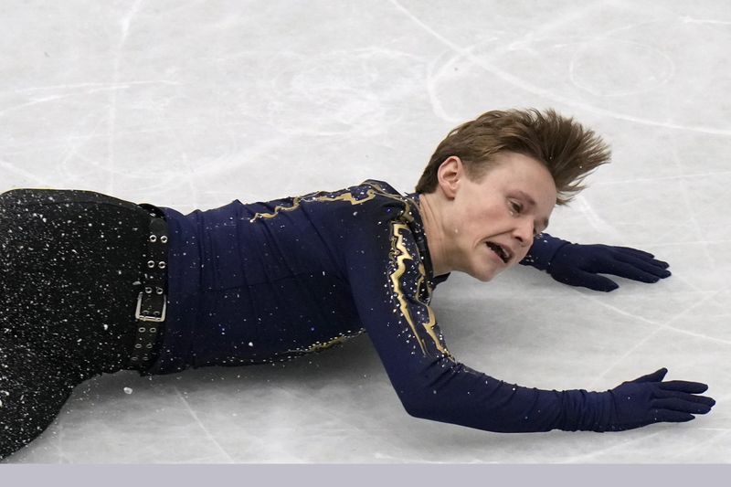 Figure skater Ilia Malinin falling on the ice