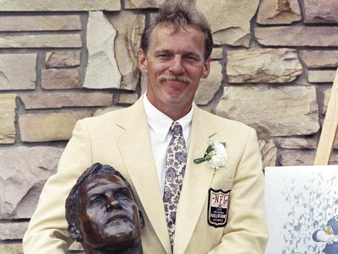 Former Pittsburgh Steelers linebacker poses with bust after being inducted into the Football Hall of fame