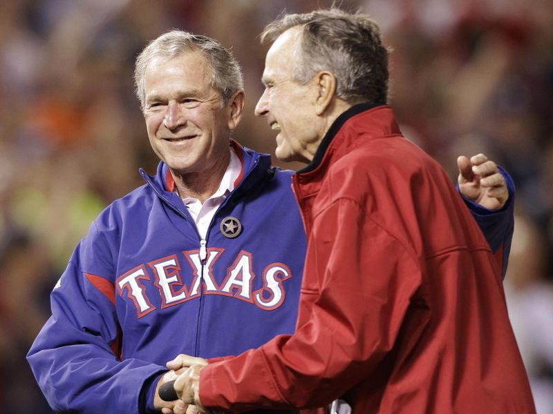 Former Presidents George Bush and his son George W. Bush arrive to throw ceremonial first pitch