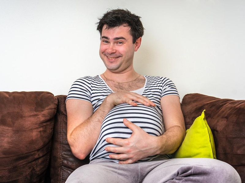 Funny image of pregnant man with pregnant belly