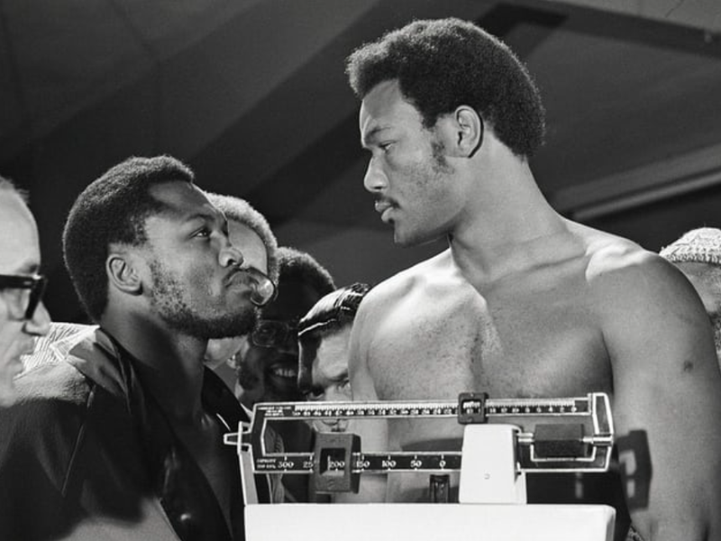 George Foreman and Joe Frazier stare at each other