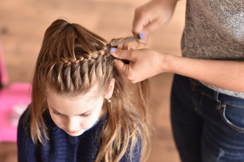 Girl getting her hair braided