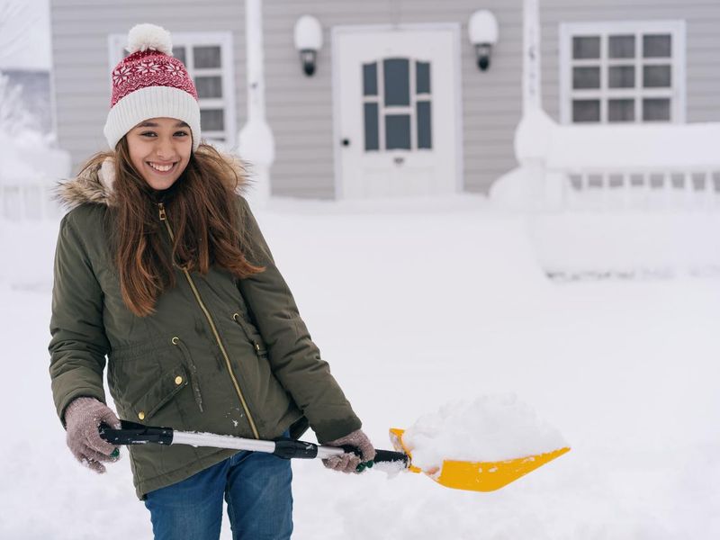 Girl holding a snow shovel