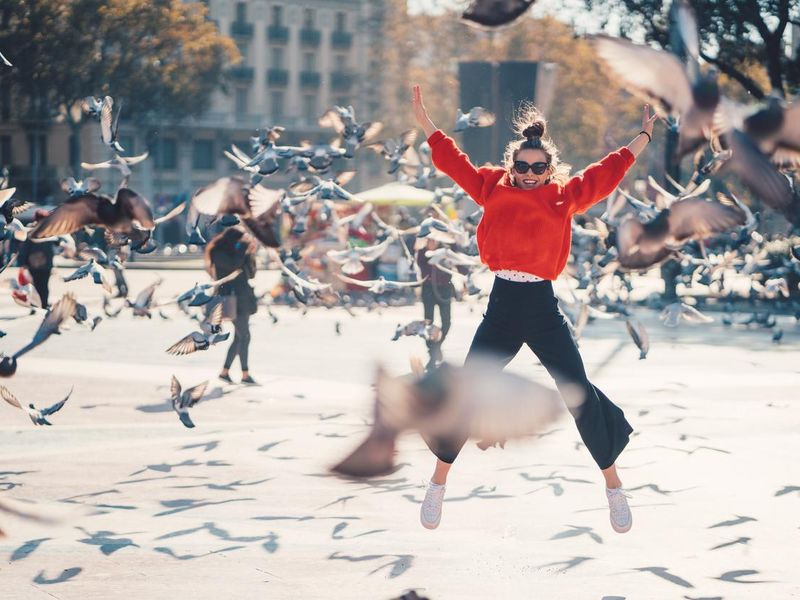 Girl jumping from joy in Barcelona
