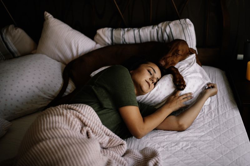 Girl sleeping with her dog