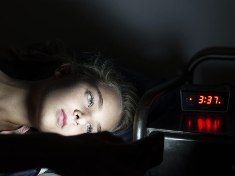 Girl using her smartphone late at night
