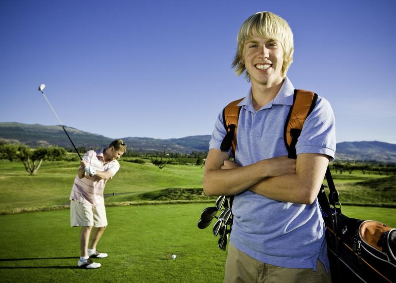 Golfer with caddy